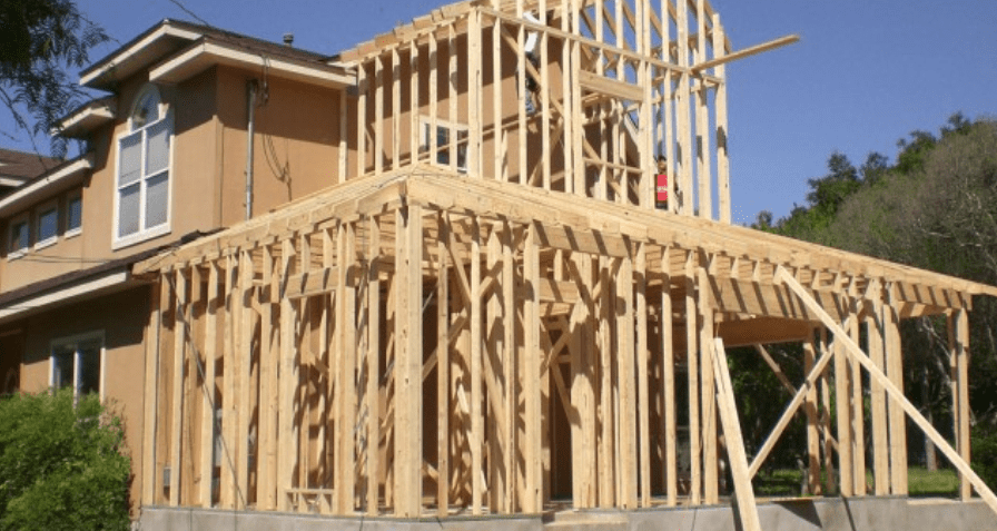 A two-story house with an addition being constructed